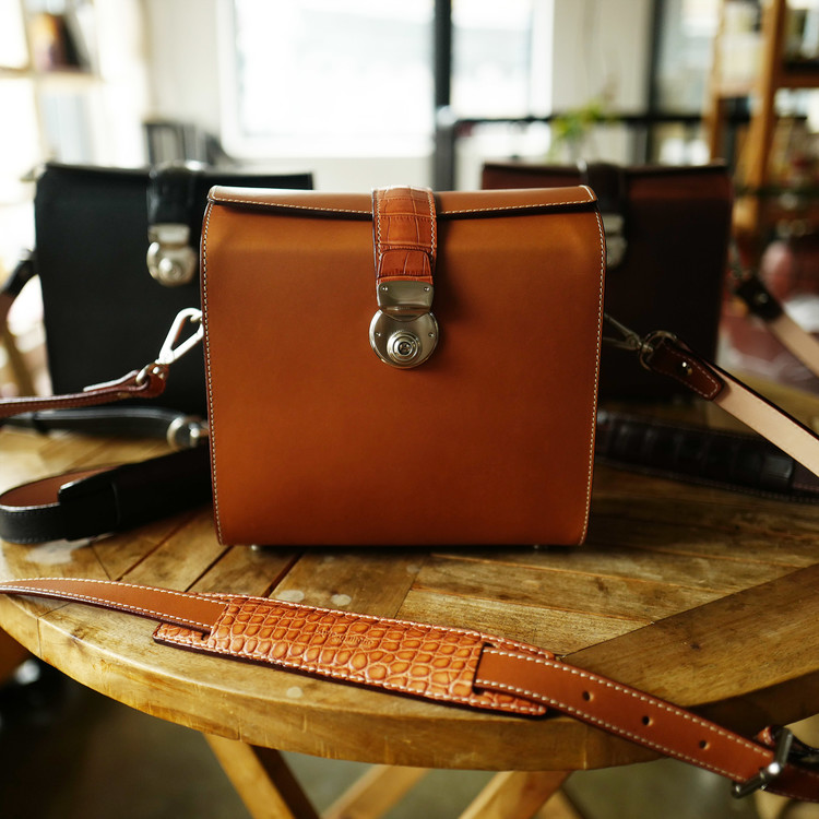 Orange Italian leather camera style crossbody bag with wide strap