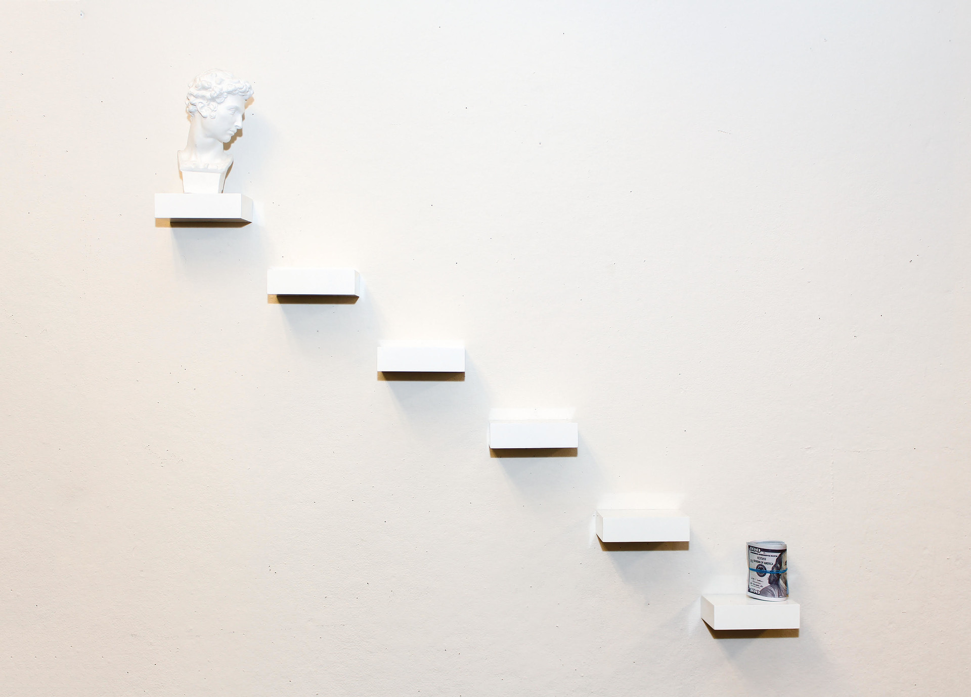“Hierarchy” / 2018 / 29inx18inx5in / sculpture head, acrylic squares, money