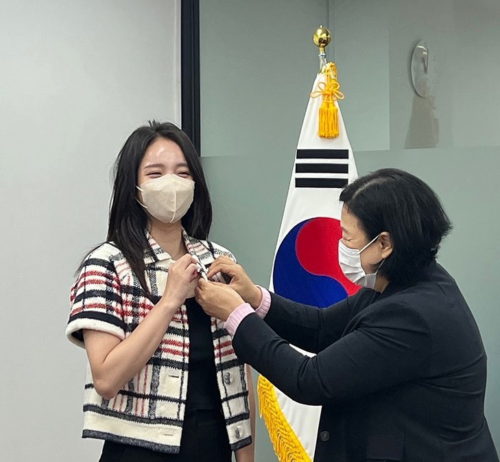 전국재해구호협회 희망브리지 측으로 부터 뱃지를 수여받고 있는 최선정 씨.