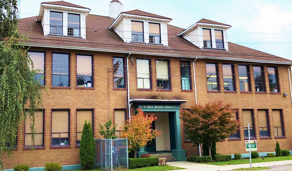 Photo of the St. Patrick Emlementary School building. It's a relatively small school building with brick wall style.