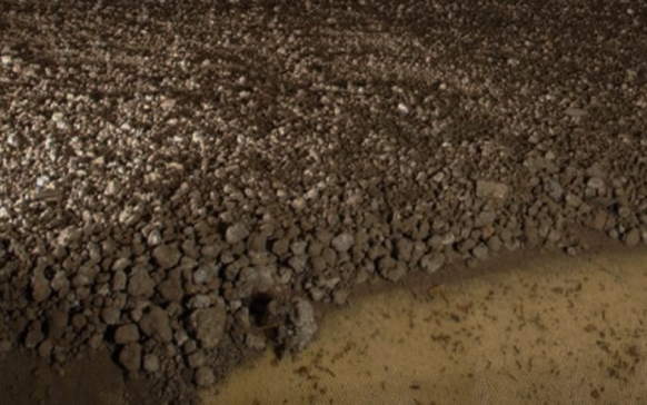 Layer of dewatered sludge cake with air gaps, highlighting the natural ventilation drying process for moisture reduction