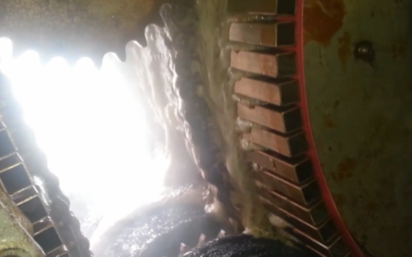 Close-up view of the dewatering process, showing machinery in operation, reducing moisture content in sludge