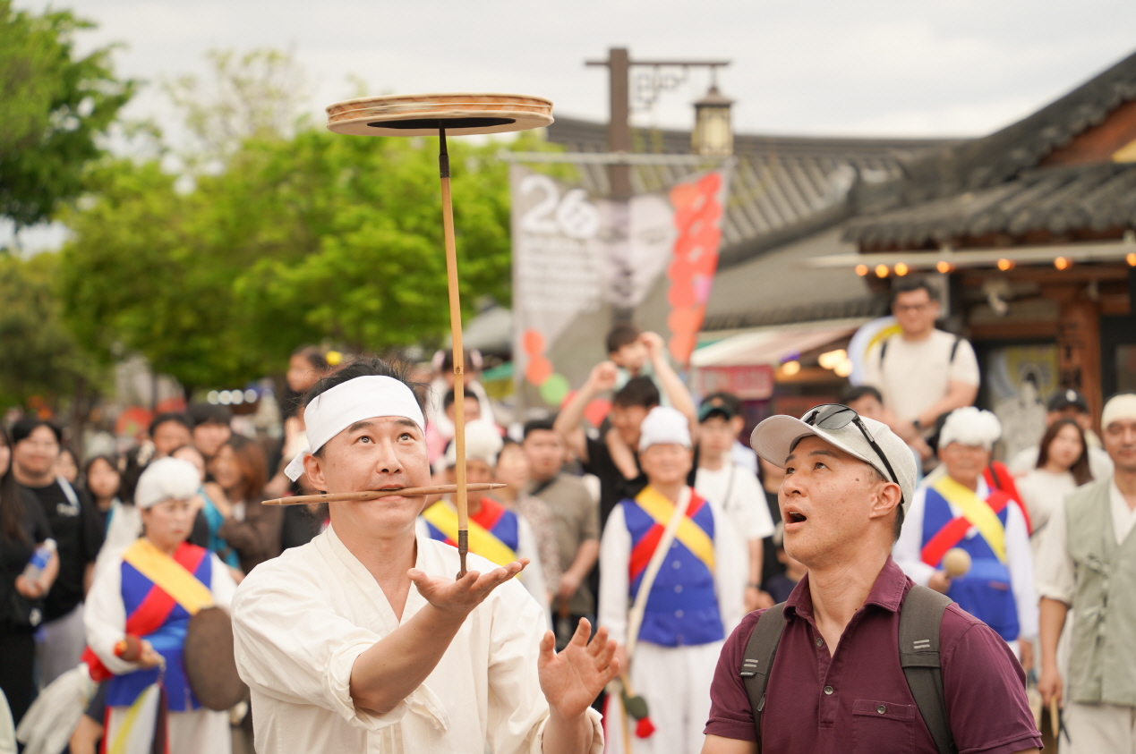전통연희단이 외국인과 함께 접시돌리기 공연을 선보이며 한국문화체험을 즐기는 모습