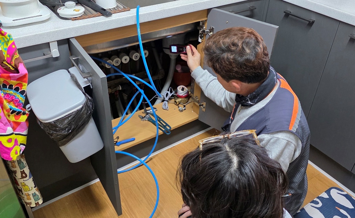 인천 계양구 아파트 주방에서 청음식 누수탐지기로 싱크대 배관을 검사하는 모습