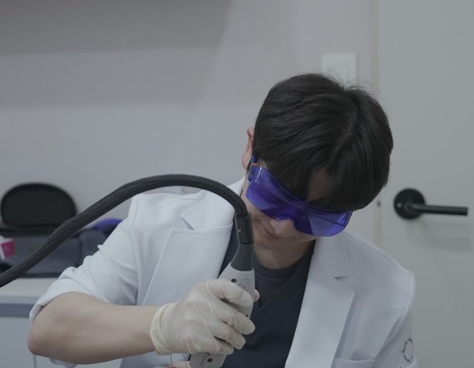 대전레이저제모 시술을 위해 보호 안경을 착용하고 레이저 핸드피스를 준비하는 사진