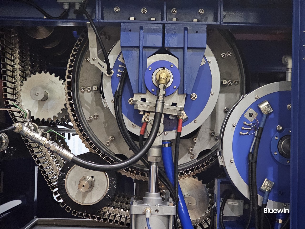 Close-up view of the dewatering process, showing machinery in operation, reducing moisture content in sludge