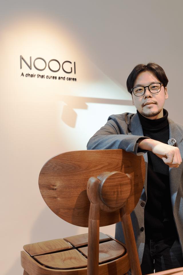 NOOGI CEO Chanwook Park with a NOOGI chair