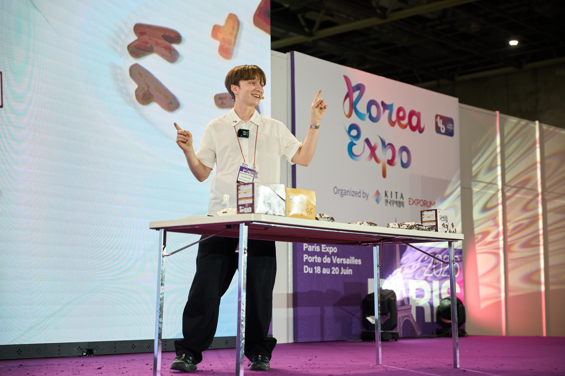 Panel discussion at Korea Expo with speakers seated on stage during a K-culture session