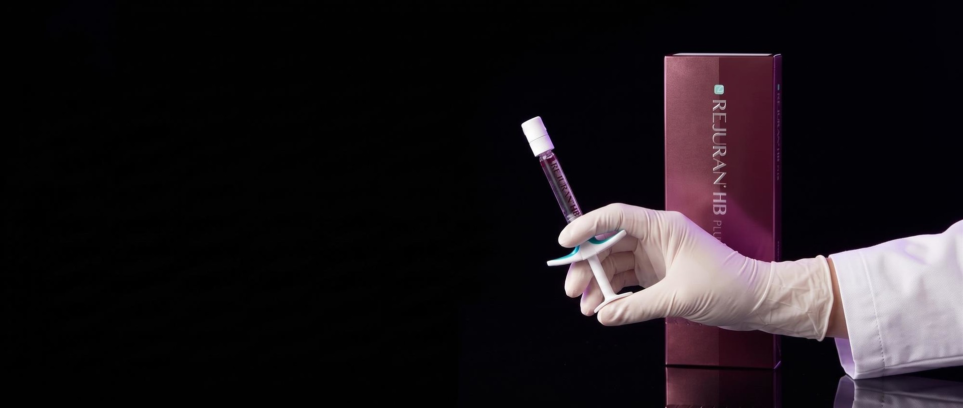 A hand holding a Rejuran HB plus syringe