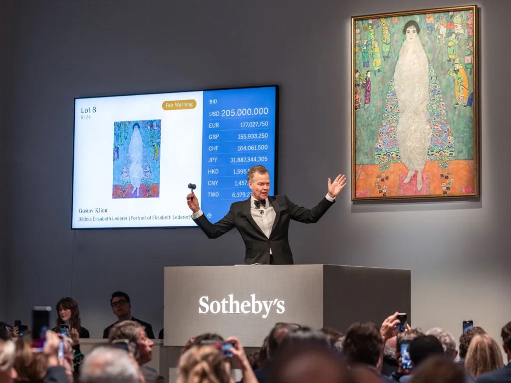 Auctioneer Oliver Barker just before he strikes his gavel to sell Gustav Klimt's portrait of Elisabeth Lederer.