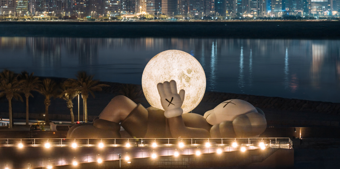 32-meter companion by KAWS lifts glowing moon along abu dhabi's waterfront