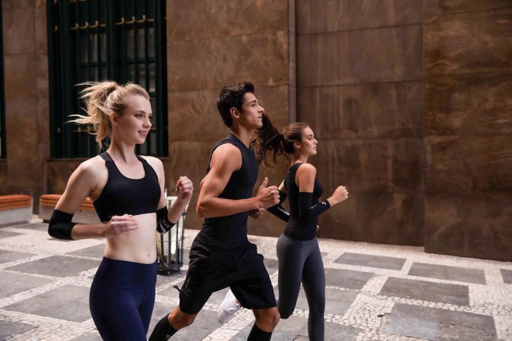 three models running in an action shot wearing the wavewear brand