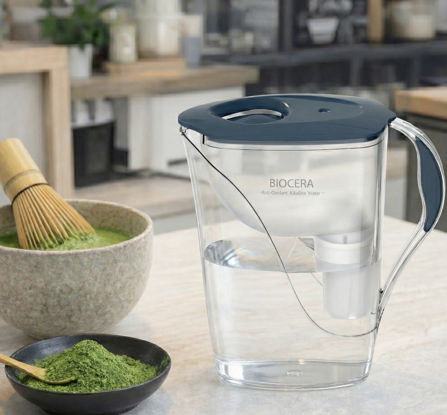 Biocera alkaline water pitcher for enhancing matcha tea flavor, shown with tea preparation tools