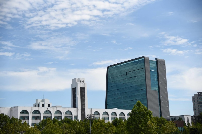 A building with trees in the background 
Description automatically generated