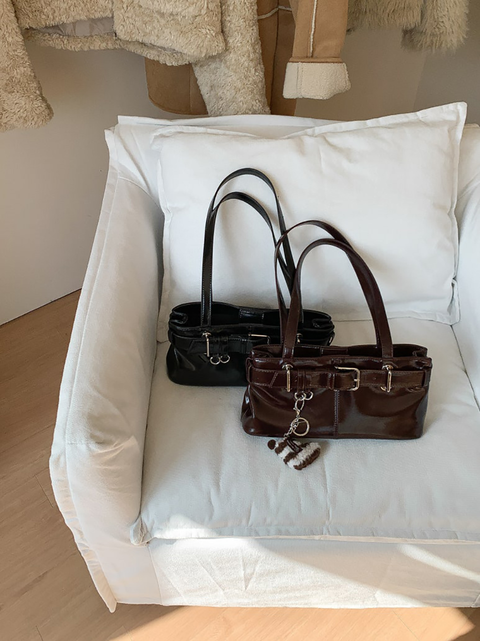 Belted glossy leather shoulder bag