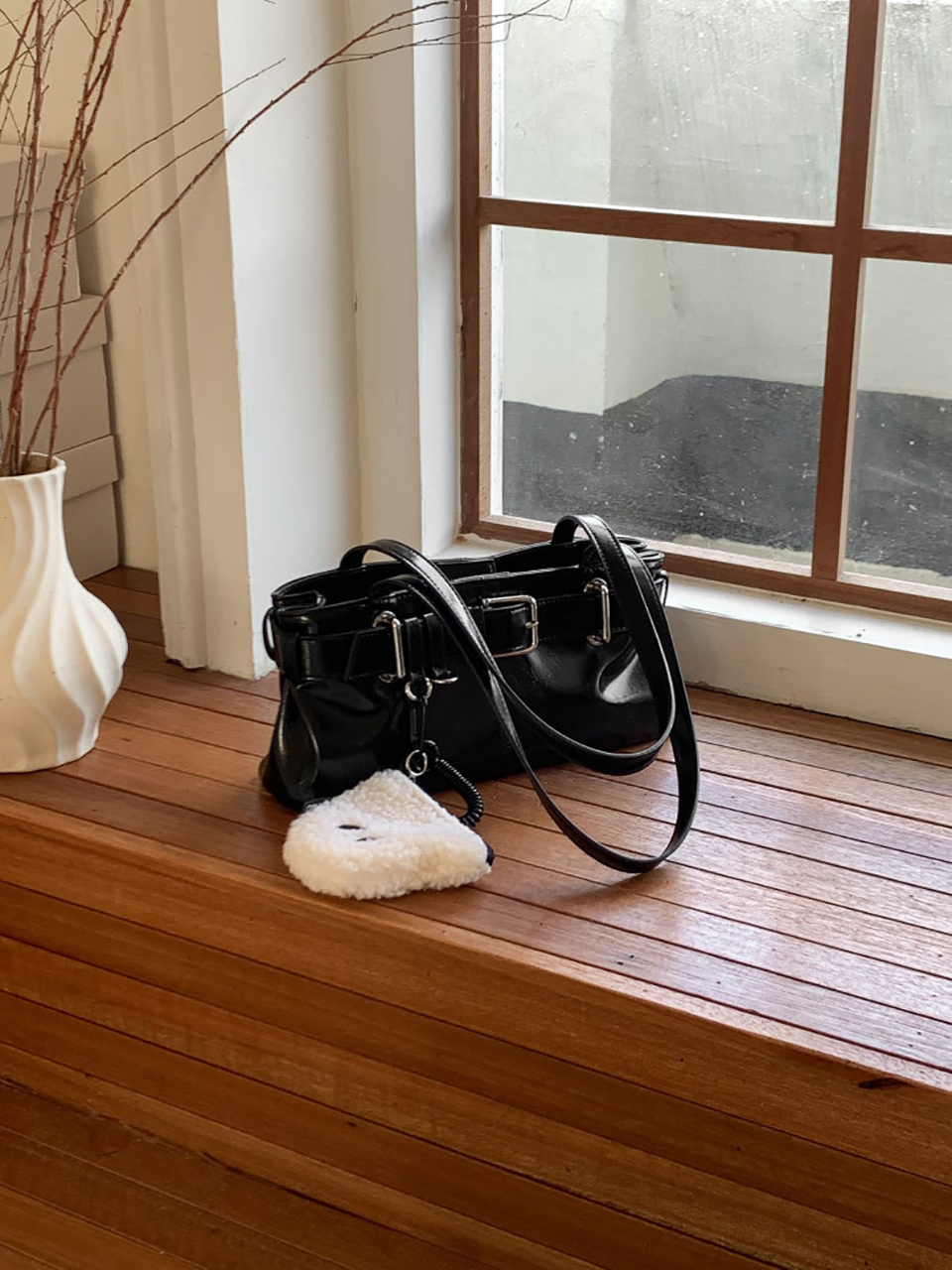 Belted glossy leather shoulder bag