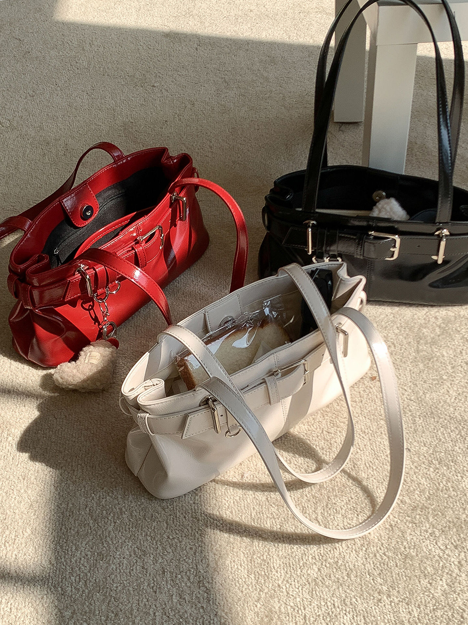 Belted glossy leather shoulder bag