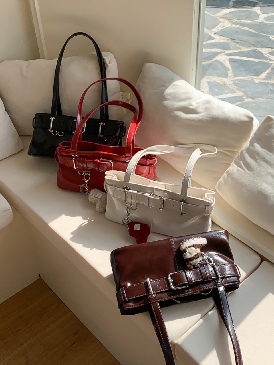 Belted glossy leather shoulder bag