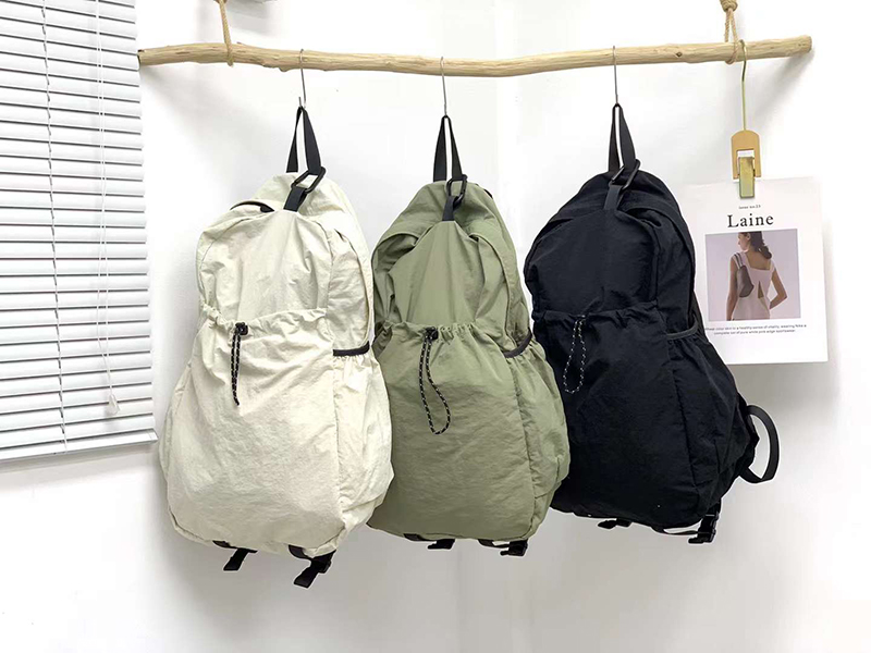 Nylon backpack with waist drawstring pockets