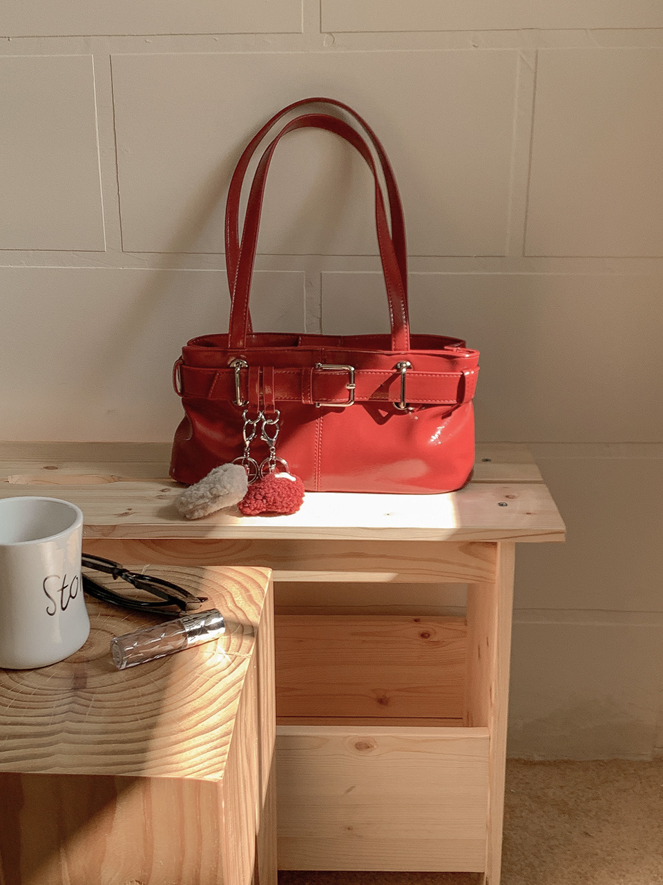 Belted glossy leather shoulder bag