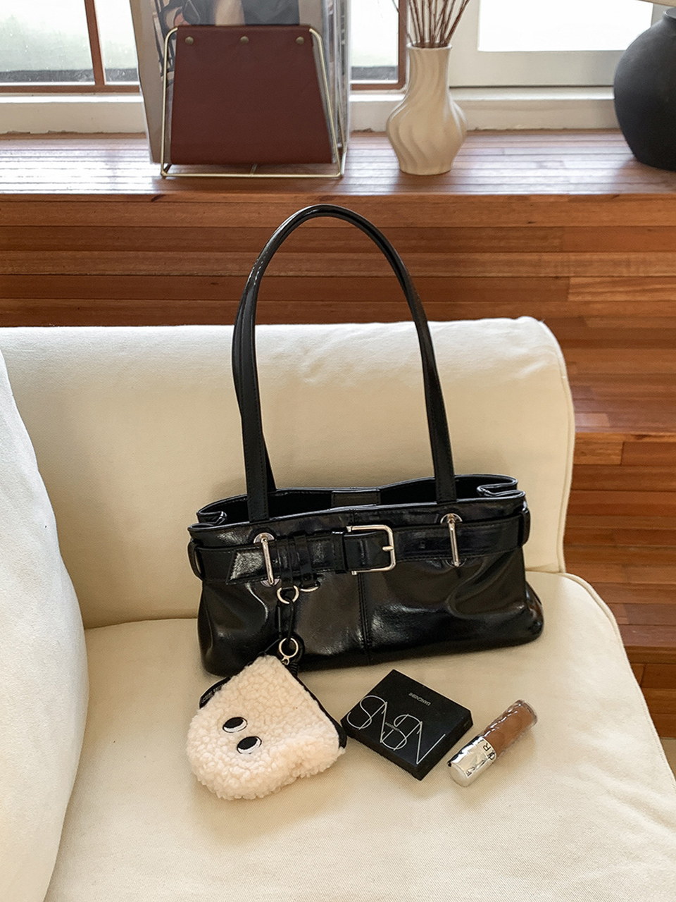 Belted glossy leather shoulder bag