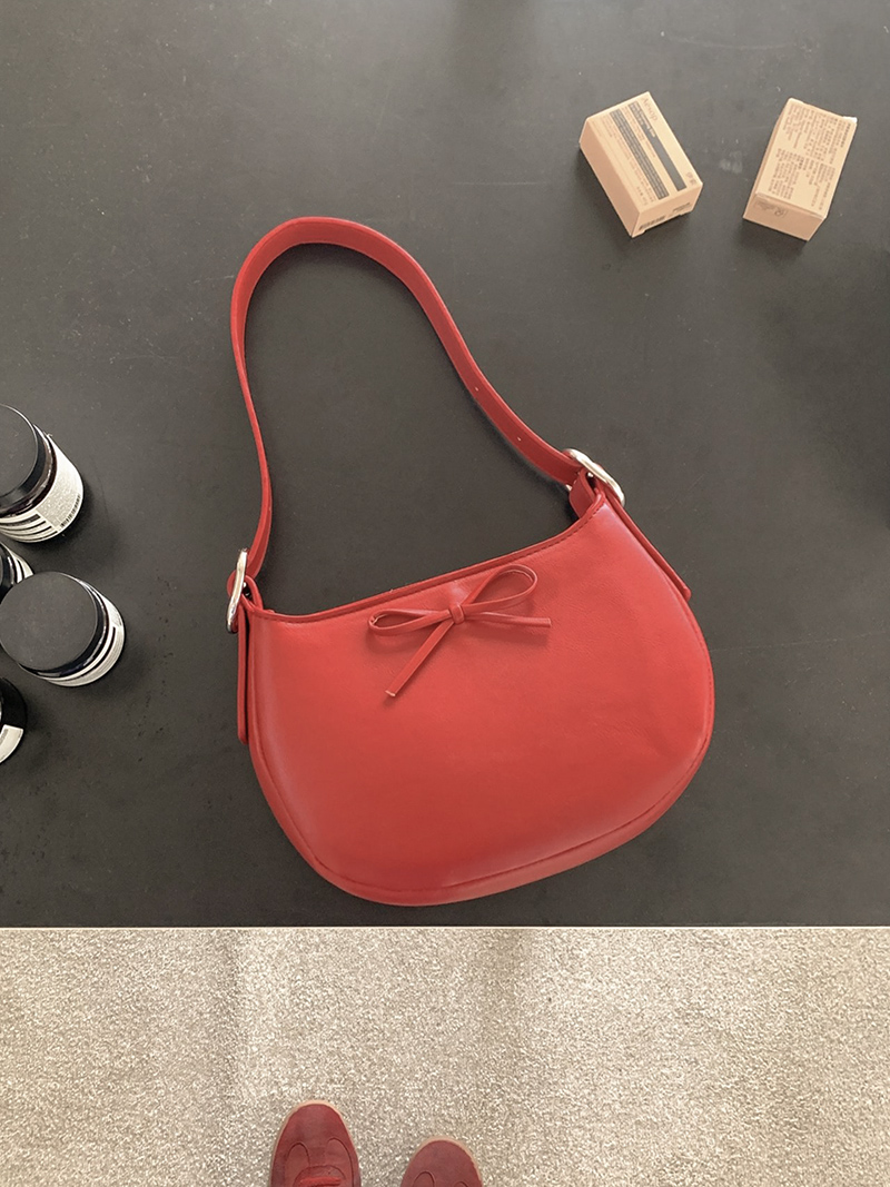Ribbon buckle round leather shoulder bag