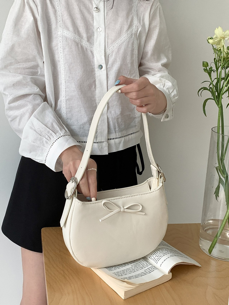 Ribbon buckle round leather shoulder bag