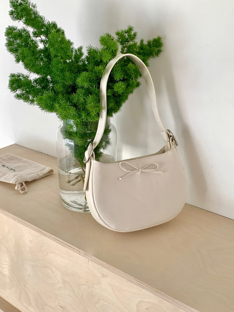 Ribbon buckle round leather shoulder bag