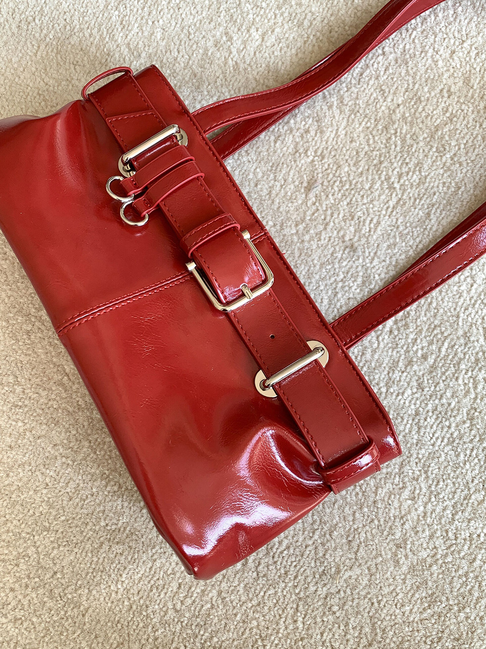 Belted glossy leather shoulder bag