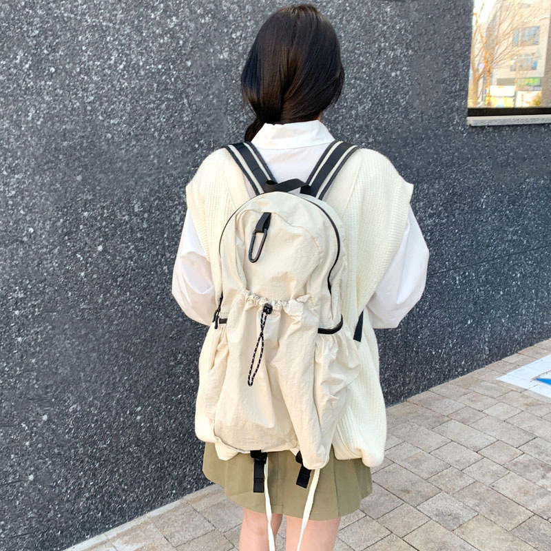Nylon backpack with waist drawstring pockets