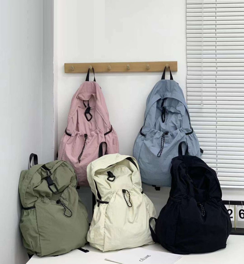 Nylon backpack with waist drawstring pockets