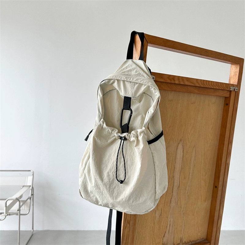 Nylon backpack with waist drawstring pockets