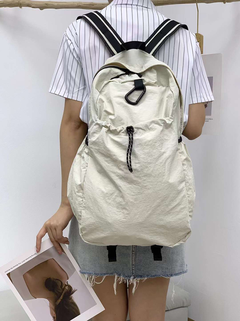 Nylon backpack with waist drawstring pockets