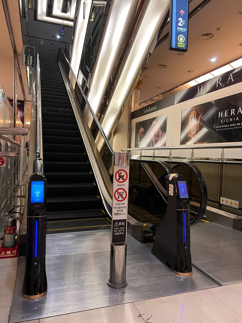 Escalator handrail Sterilizer WeClean at DEBEC department store, 2