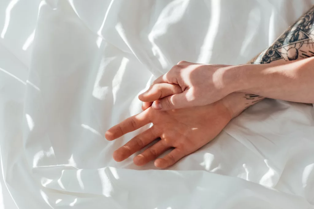 partial view of loving couple holding hands while 2024 11 17 15 19 01 utc