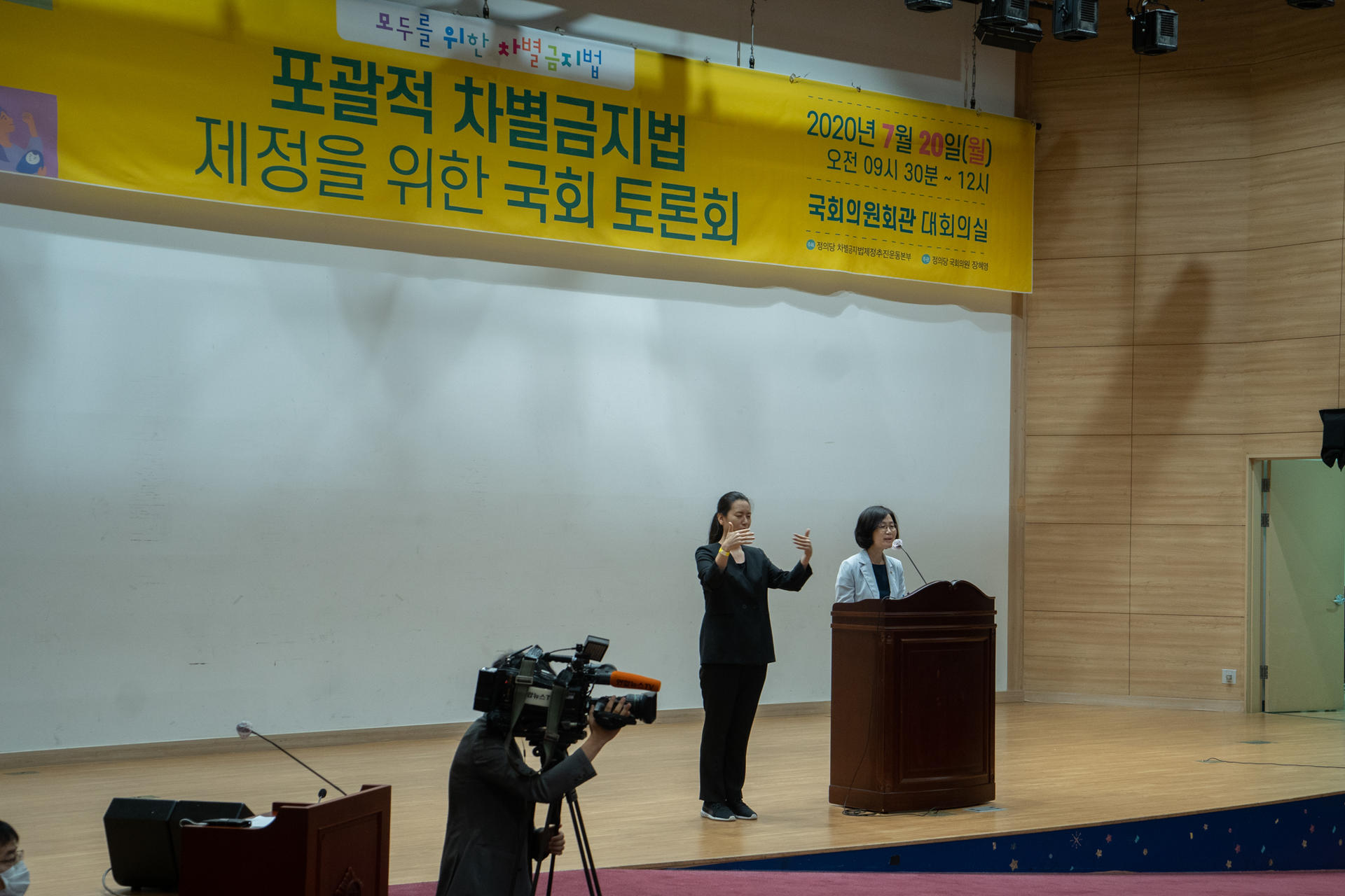 포괄적 차별금지법 제정을 위한 국회 토론회에서 축사를 하고 있는 권인숙 의원과 수어통역사의 사진입니다.