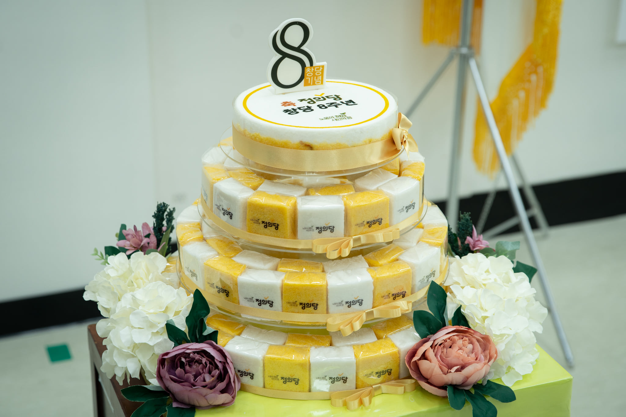정의당 창당 8주년 기념행사에 비치된 떡케이크 사진. 노란색과 흰색 백설기에 모두 정의당 로고가 박혀있는 4층짜리 케이크