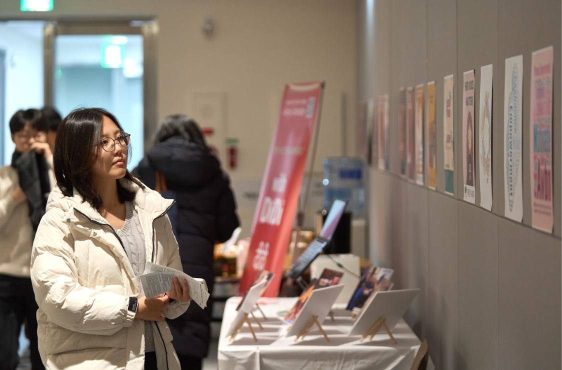 공유포럼 참석자가 AWBN 수료생 포스터를 관람하고 있다.