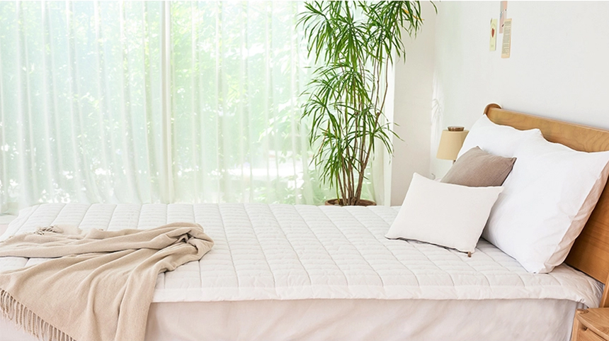 White Dr.Friend Sleep Pad placed in a sunlit bedroom with plants, highlighting a bright and refreshing interior mood