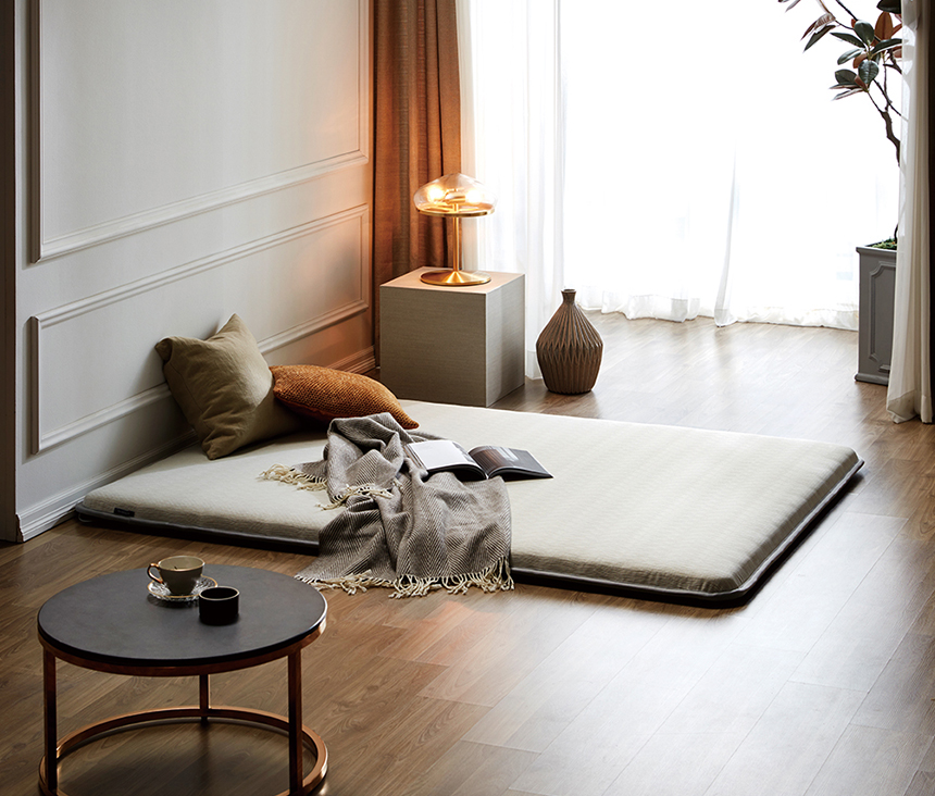 Dr.Friend grounding sleep mat placed on the floor in a minimalist living space, showing a calm and comfortable sleep environment"