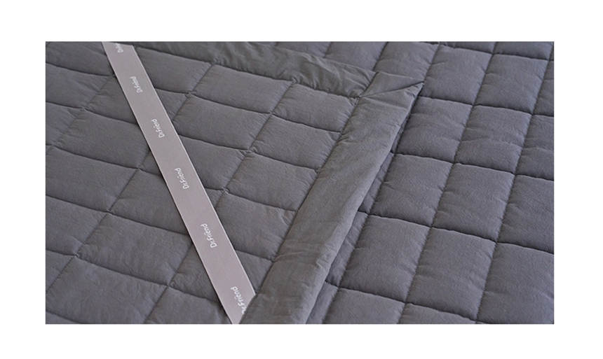 Detailed view of the charcoal Dr.Friend Sleep Pad fabric showing quilted stitching and smooth cotton texture