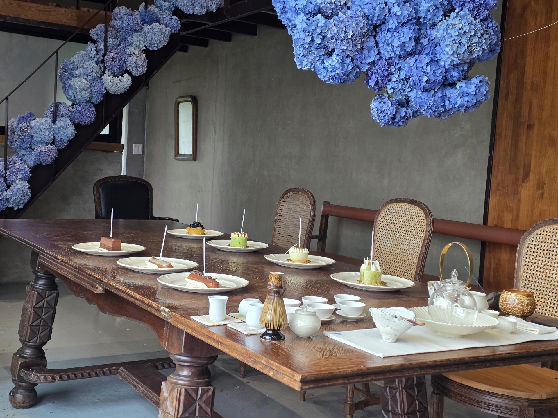 Vibrant blue hydrangeas blooming beautifully under the June rain in Jeju