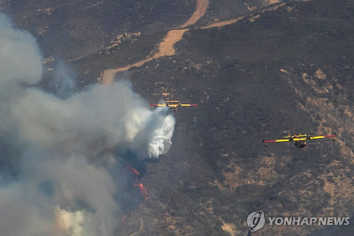 23일 LA 북부 캐스테이크호 인근에서 '휴스 산불' 진화 중인 항공기