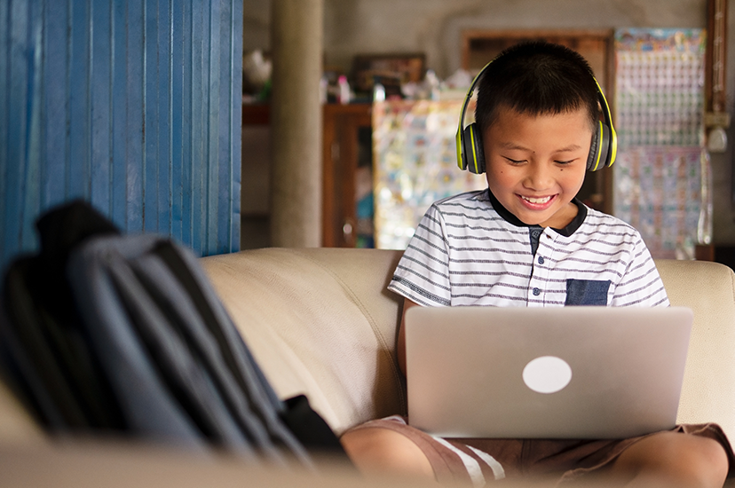 boy on laptop for distance learning or remote learning or hybrid learning making reading gains with Fast ForWord