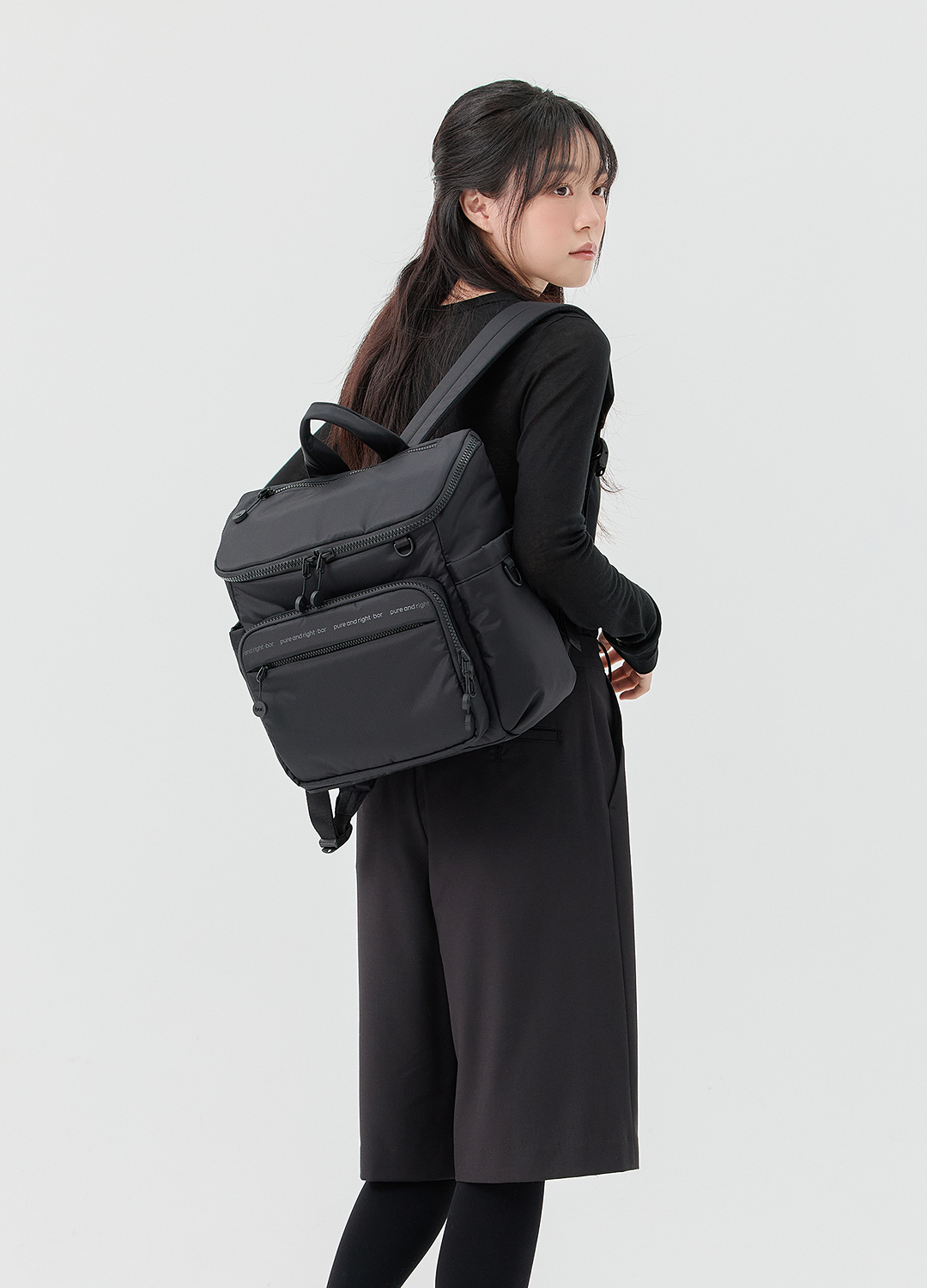 미니 백팩을 착용한 모델의 후면 모습으로 전체 비율과 착용감을 보여주는 컷