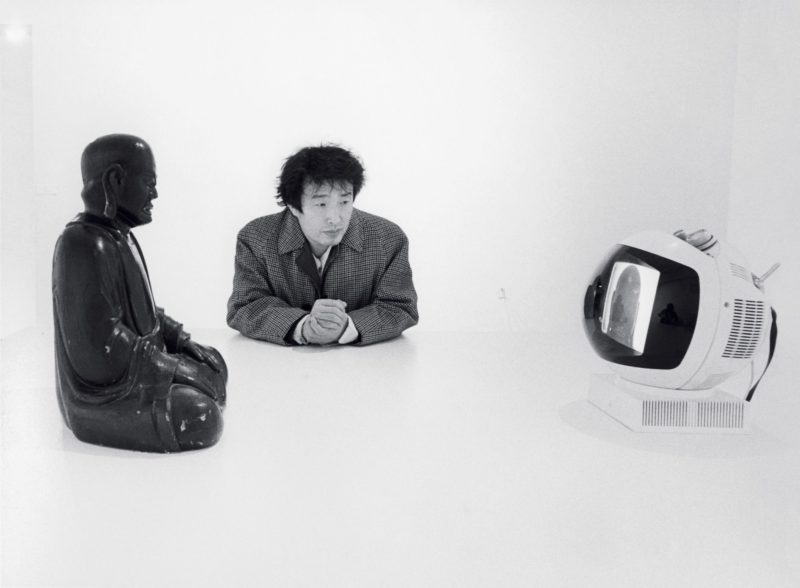 Nam June Paik and his Buddha TV, 1974, at Projects: Nam June Paik (August 29-October 10, 1977), Museum of Modern Art, New York, 1977, photo: Eric Kroll