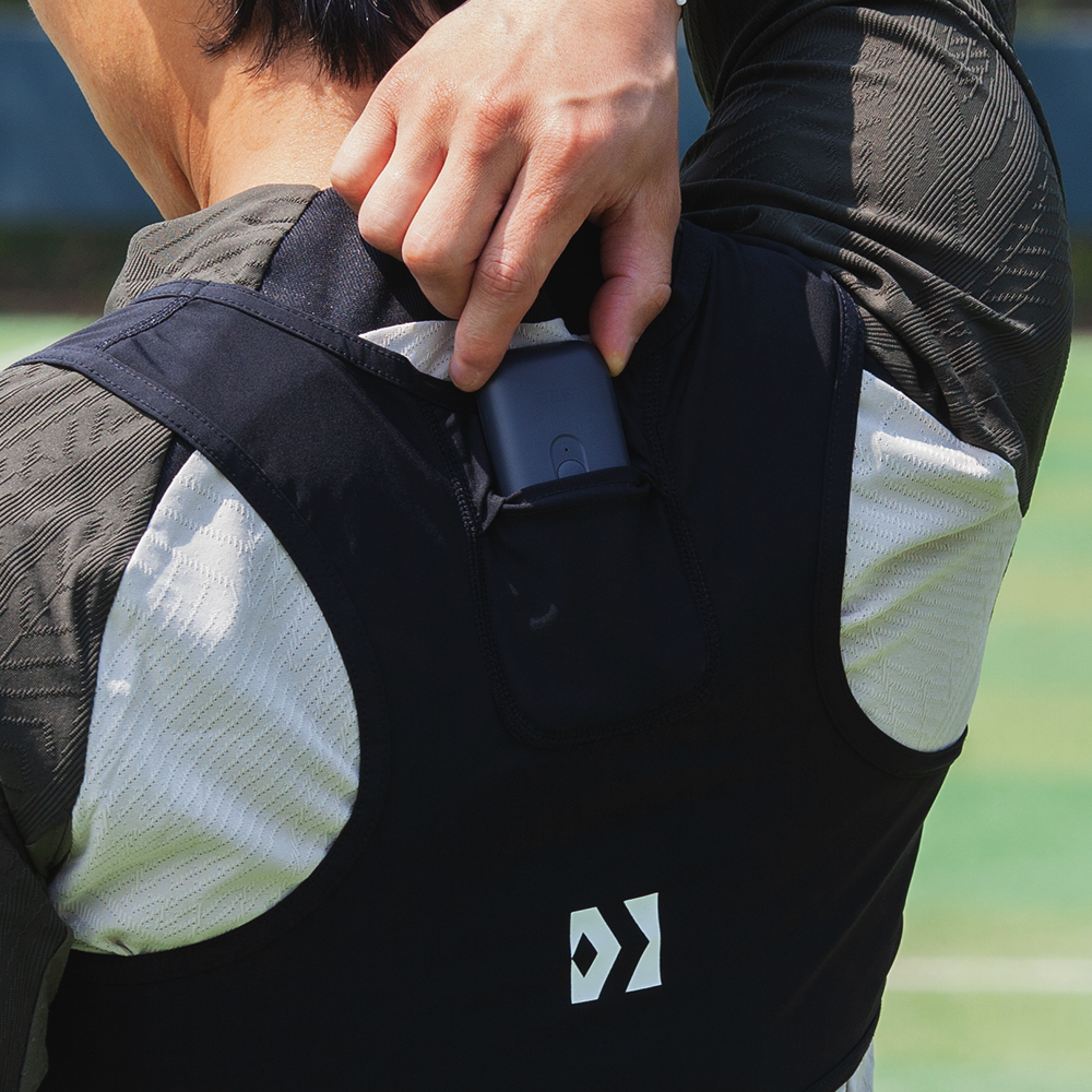 Placing the GPS Tracker in the back pocket of the vest