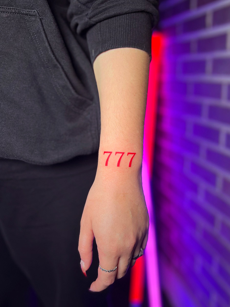 Korean tattoo artist preparing angel number tattoo