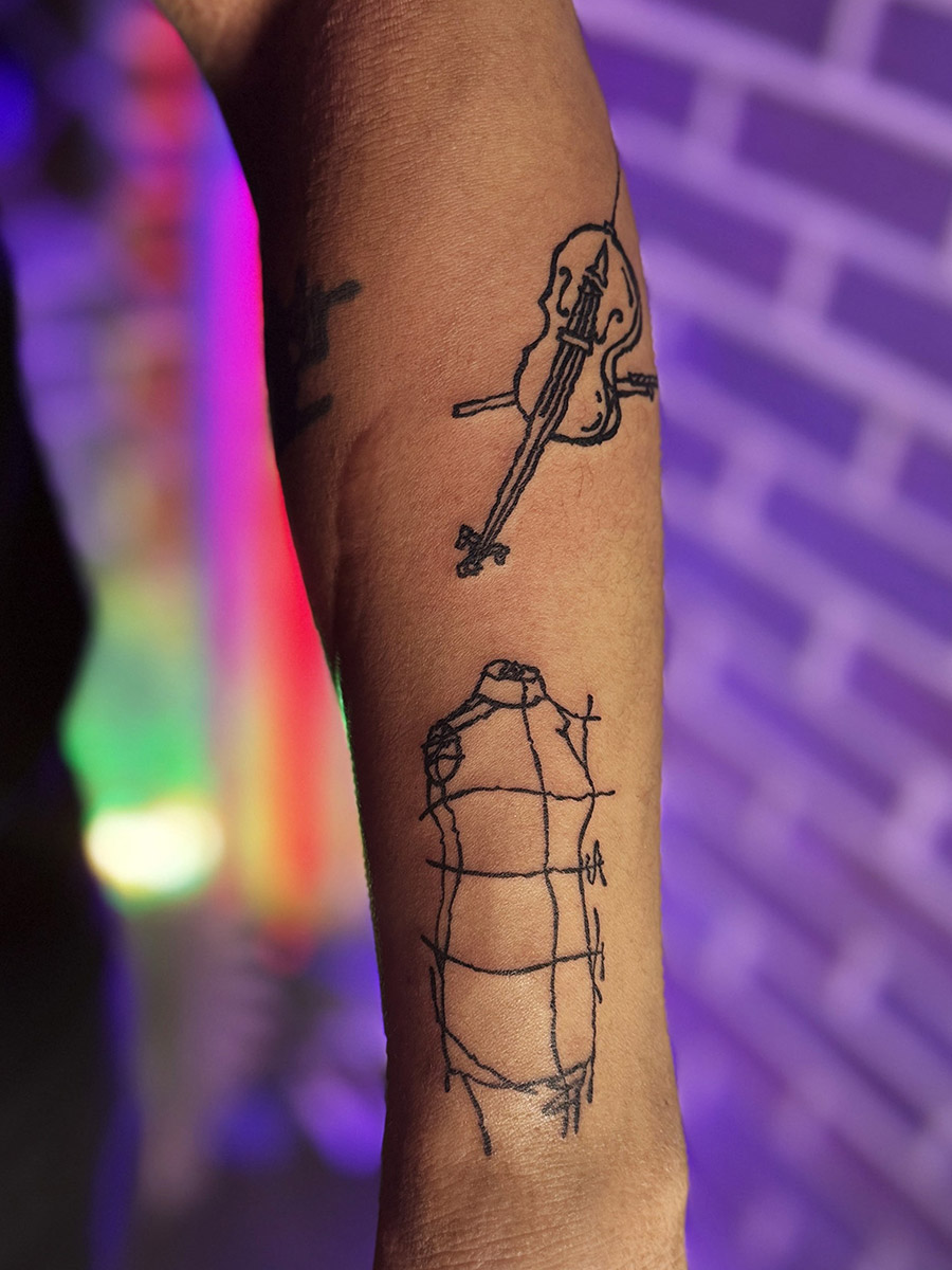 Tattoo artist in Hongdae Seoul working on detailed tattoo