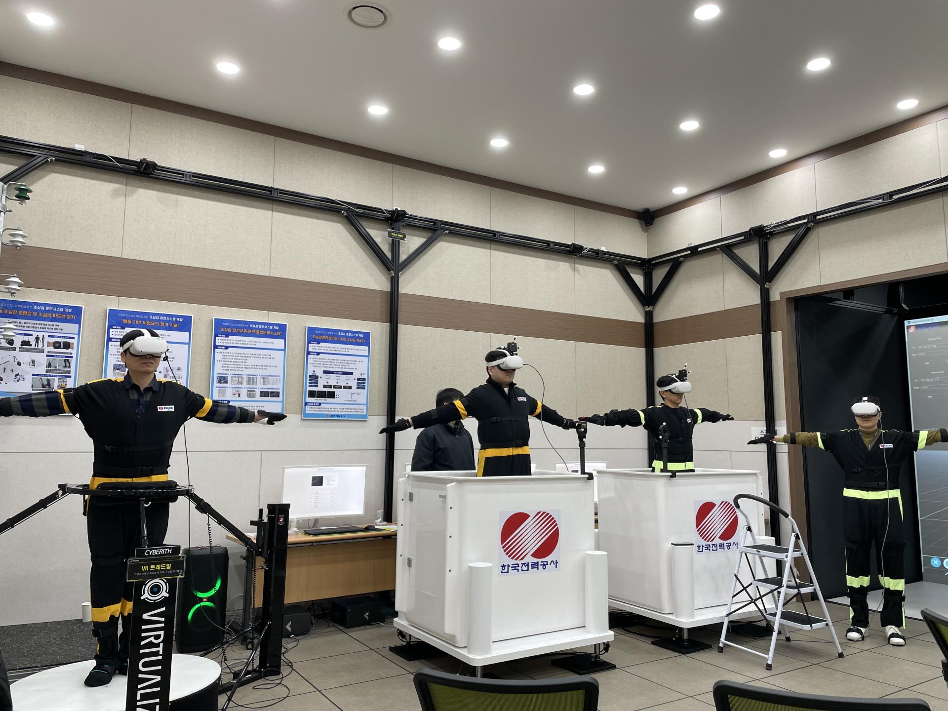 Users trying iPOP VR training platforms with headsets and safety harnesses